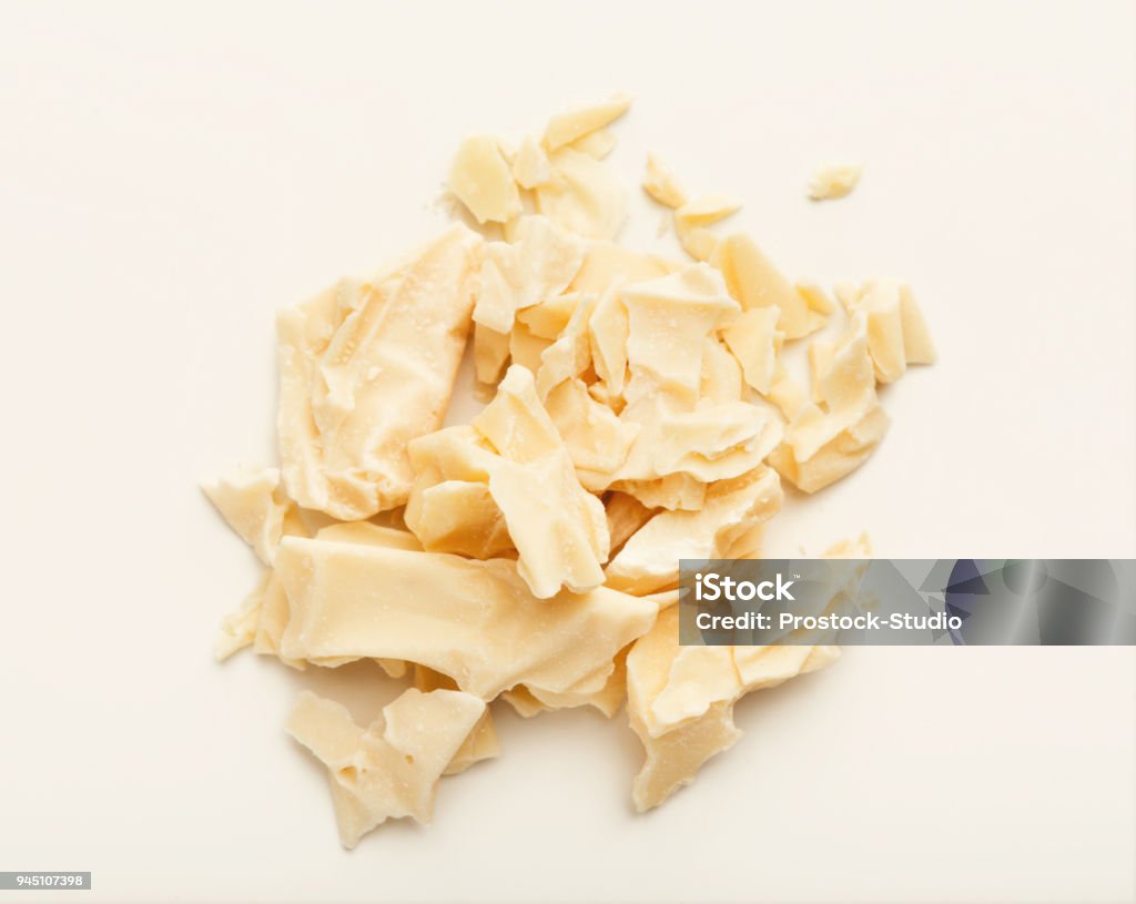 Cocoa butter isolated on white Pieces of cocoa butter isolated on white background. Heap of white chocolate, cutout Butter Stock Photo