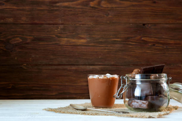 istock Delicious chocolate smoothie with marshmallows on dark table 945109836