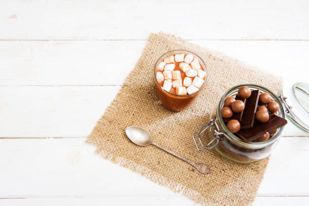 istock Chocolate shake with marshmallows on white wooden table 945109906