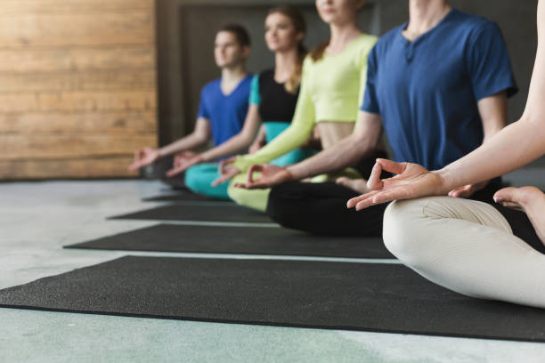 istock Young people in yoga class, relax meditation pose 945109992