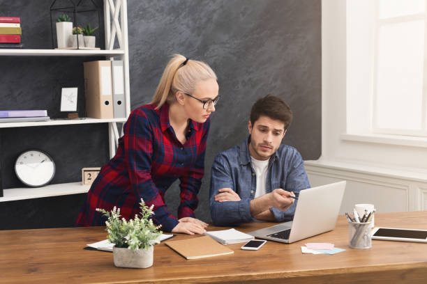 istock Couple of business partners work at modern office 945113126