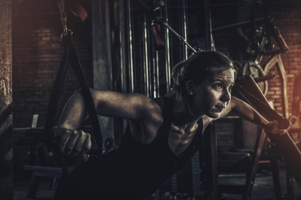 close up woman doing exercises in the gym. Fitness and healthy lifestyle concept close up woman doing exercises in the gym. Fitness and healthy lifestyle concept. blonde female bodybuilders stock pictures, royalty-free photos & images