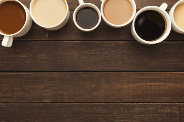 istock Different types of coffee in cups on wooden table, top view 945113398