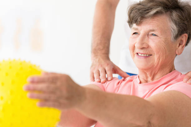 istock Woman holding ball in physiotherapy 945113774