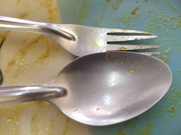 istock Empty blue mixed white ceramic dish with traditional Thai style chicken tracery on the dish spoon and fork on top view. After meal let be full and sleepy. Thai culture must eat until last rice seed. 945114084