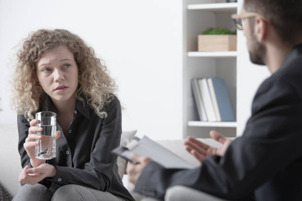 istock Young woman talking to psychologist 945116646