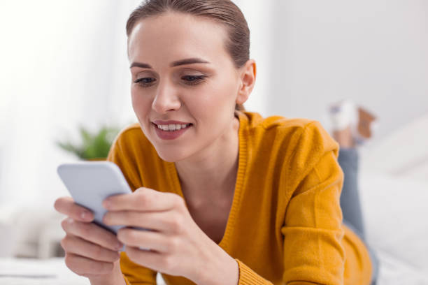 istock Kind attractive woman concentrating on phone 945116812