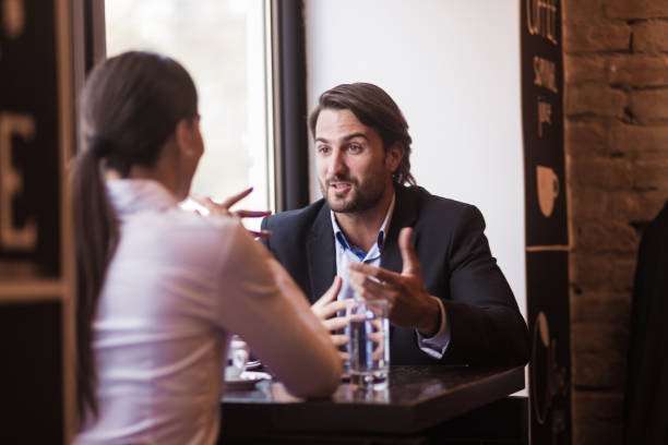 istock Two colleagues having an unofficial conversation after work in cafe 945117450