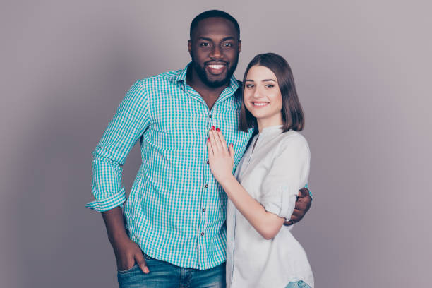 istock two mixed race people hugging at date.  Handsome afro american guy standing together with his  beautiful caucasian girl 945120104