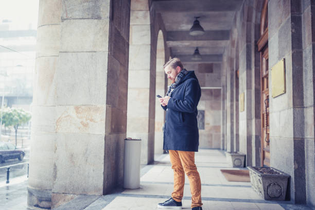 istock Ginger businessman using mobile phone outdoors 945120284