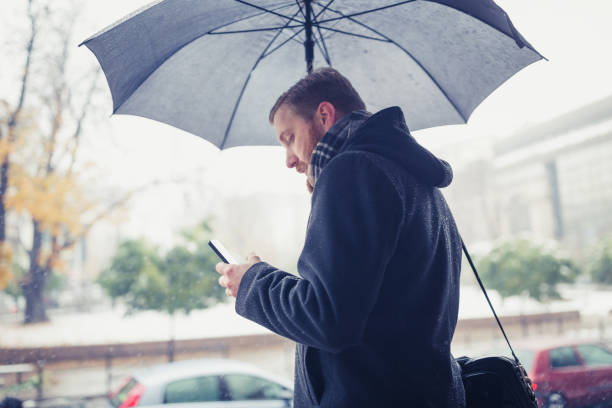 istock Ginger businessman using mobile phone outdoors 945120334