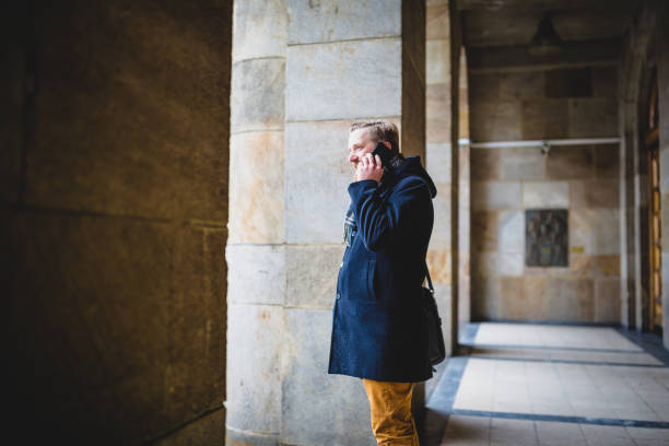 istock Ginger businessman using mobile phone outdoors 945120378