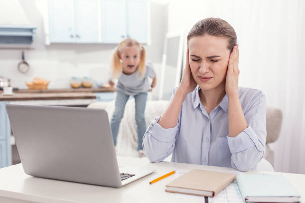 istock Stressful single mother obstructing from kids screaming 945121438