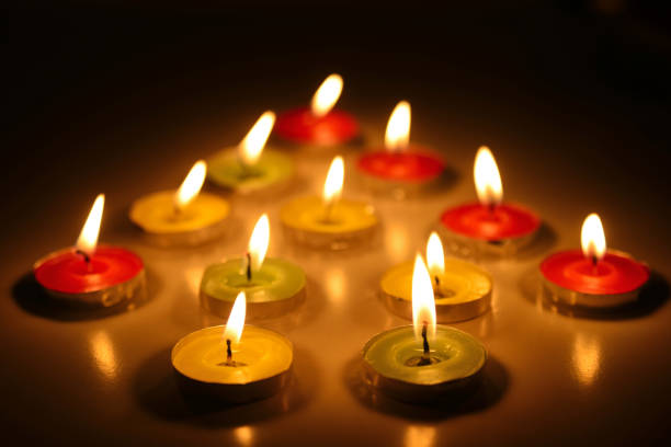 istock Multicolored lighted candles in the form of a Christmas tree 945125340