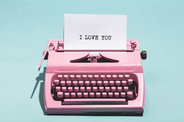 "I love you" writing and pink typewriter. Pink vintage typewriter with a white sheet of paper and "I love you" written on it. Love concept. publisher photos stock pictures, royalty-free photos & images