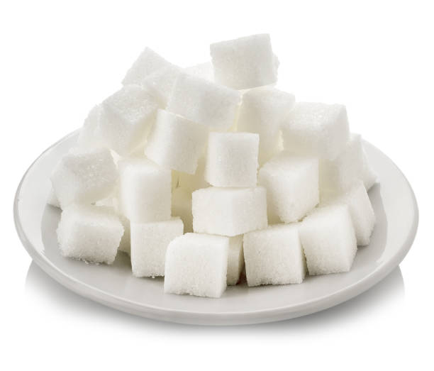 istock Cubes of white sugar in a white saucer 945136282