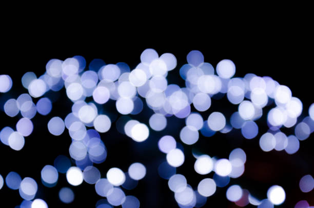 istock Colored lights, garlands. Blurred photo. Celebratory background. 945140954