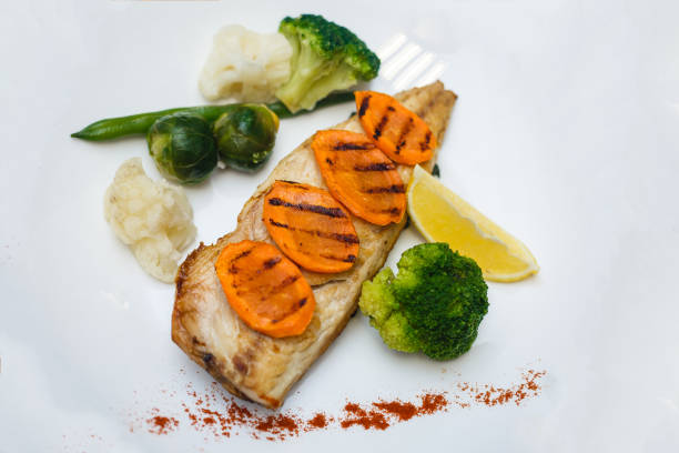 istock Baked mackerel fish stuffed with carrots. Top flat view. Close-up. 945141628