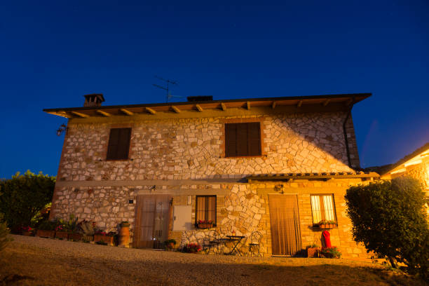 istock stone farm house illuminated at night in Tuscany 945144106