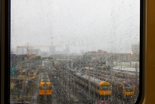 Train yard seen through rainy train window in Brisbane Australia