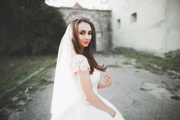 istock Happy beautiful young bride outside on a summer meadow at the sunset 945144926