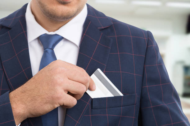 istock Anonymous businessman placing empty credit card 945145476
