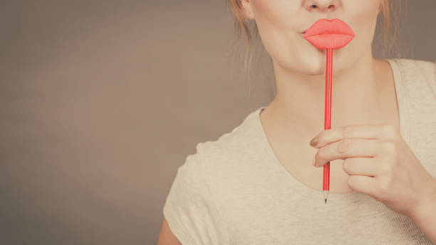 istock Happy woman holding fake lips on stick 945148690