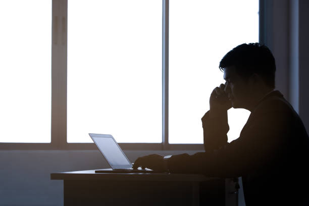 istock silhouette young business man typing laptop, office man working 945148872