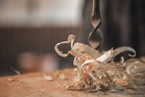 Metal drill bit makes a hole in the wood