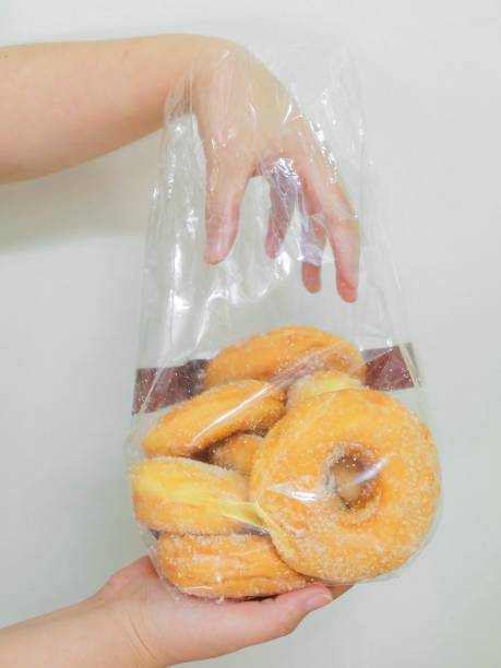 istock Hand Holding A Bag of Donuts with Sugar 945151778