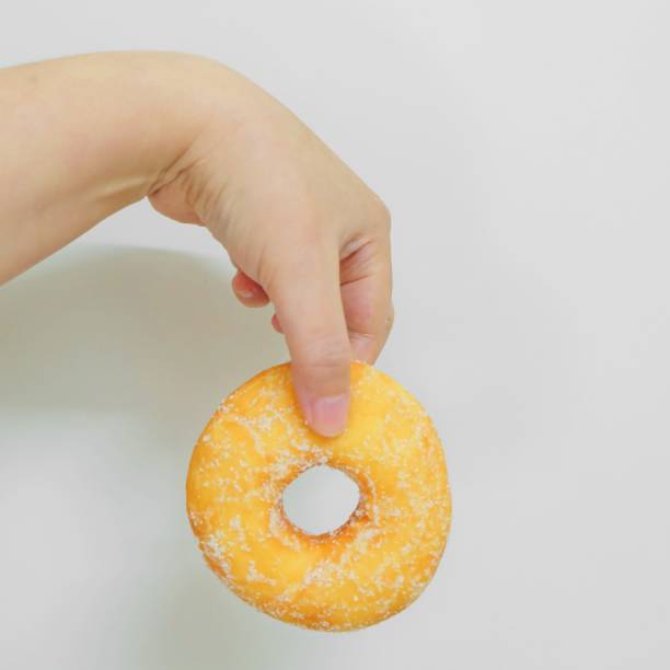 istock Hand Holding A Bag of Donuts with Sugar 945151930