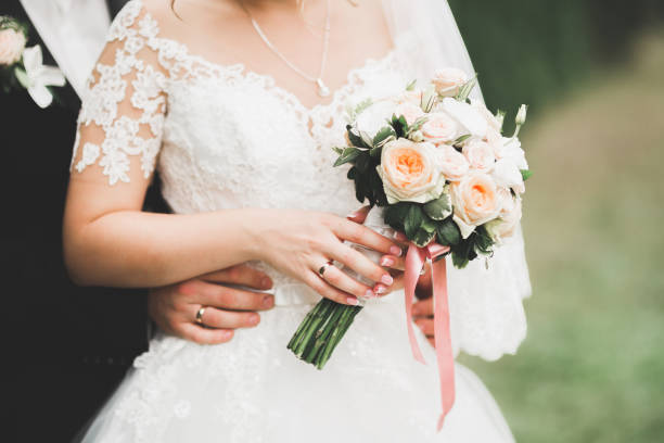 istock Bride holding big and beautiful wedding bouquet with flowers 945152686