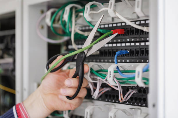 istock Cutting the network cable with scissors connected to the communication equipment 945155298
