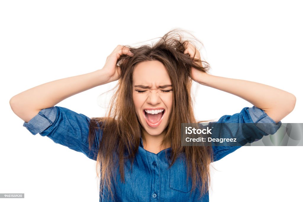 Angry sad young woman with damaged hair screaming Women Stock Photo