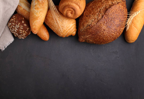 istock white, gray and rye bread, baguette, roll with sesame seeds 945156270
