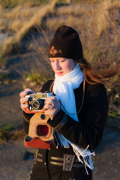 istock A girl photographer with an old camera 945158786