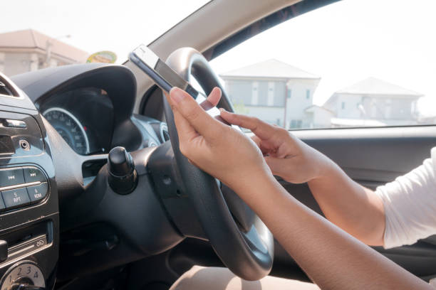 istock Hands of woman using mobile smart phone in the car 945165254