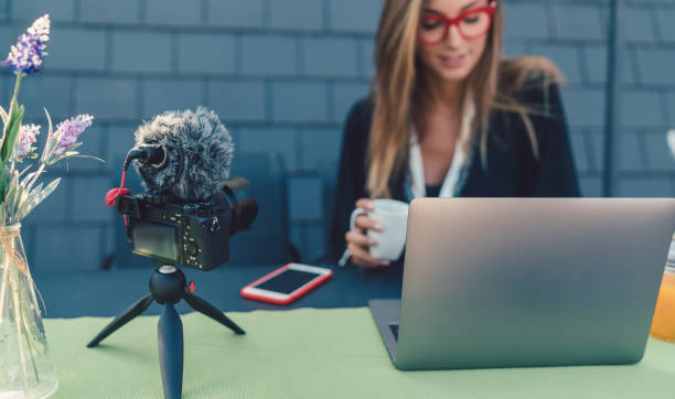 istock Young woman vlogging at rooftop terrace 945169696