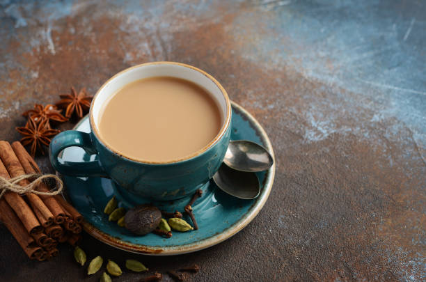 istock Indian masala chai tea. Spiced tea with milk on dark rusty background. 945169956