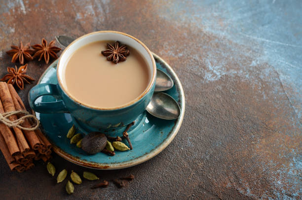 istock Indian masala chai tea. Spiced tea with milk on dark rusty background. 945169970