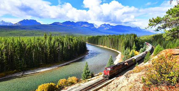 Long freight train Canadian Pacific Railway (CPR) moving along Bow river in Canadian Rockies ,Banff National Park, Canadian Rockies,Canada.