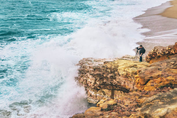 istock Photographer taking photos at the cliff 945173992