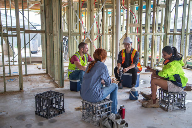Group of construction workers sit on crates, lunchtime conversation, Australia Austrlian,construction industry,diverse, construction lunch break stock pictures, royalty-free photos & images