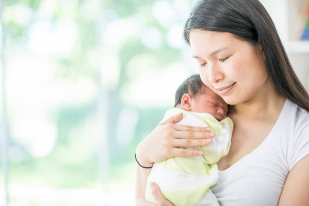 istock Peaceful mother with newborn child 945182502