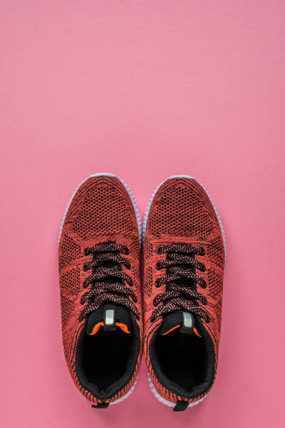 istock Sneakers on a pink background top view copy space 945183416