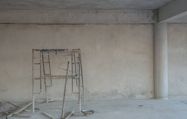 istock Interior construction of warehouse concrete wall and scaffolding. 945193046