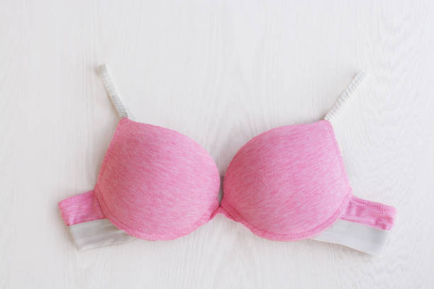 istock Bra pink sporty on white wooden background 945199676