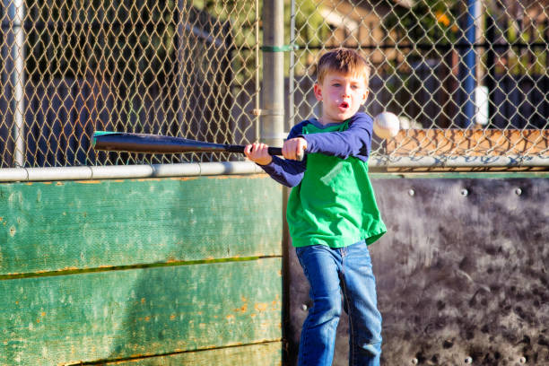 Cute little boy is playing with bubbles in the back yard.