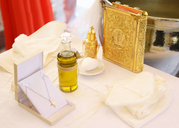 Orthodox greek Christening decoration - baptism oil, cross and the New Testament traditional greek Christening decoration - baptism oil, cross and the New Testament pics of the godmother stock pictures, royalty-free photos & images