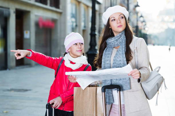 istock adult female and daughter with map 945207036